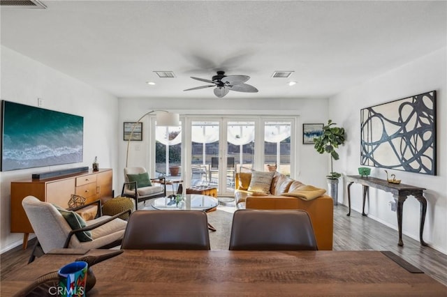 living room with ceiling fan and hardwood / wood-style flooring