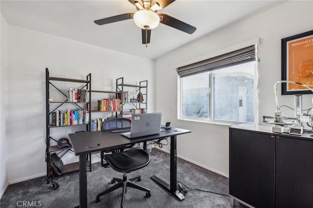 home office with ceiling fan and dark carpet