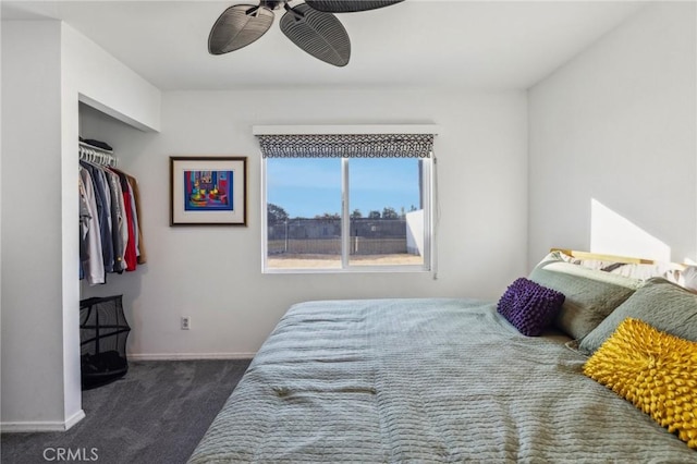 bedroom with ceiling fan, a closet, and dark carpet