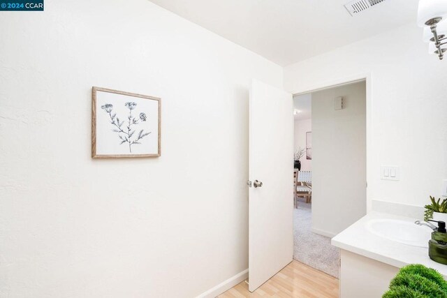 bathroom with vanity and hardwood / wood-style floors