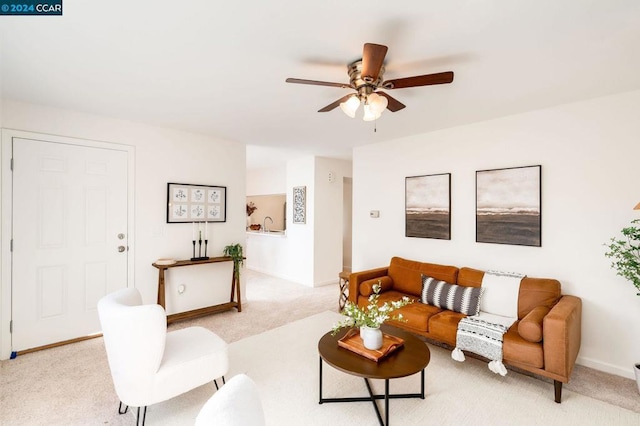 carpeted living room featuring ceiling fan