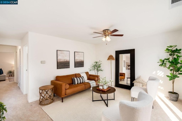 carpeted living room featuring ceiling fan