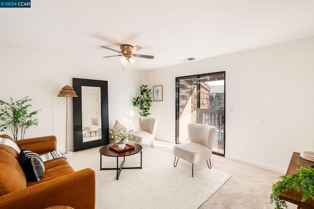 living room with ceiling fan and light carpet