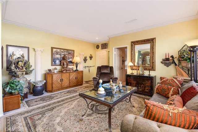 living room with decorative columns and crown molding