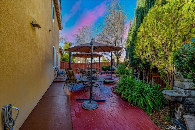 view of patio terrace at dusk