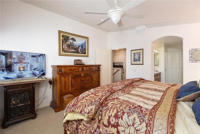 carpeted bedroom with ceiling fan, crown molding, and connected bathroom