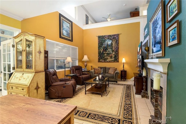 interior space featuring ceiling fan, a wealth of natural light, a towering ceiling, and light tile patterned flooring