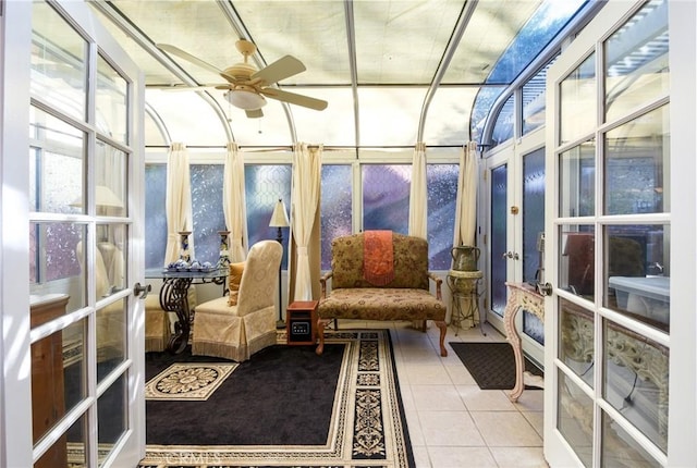 sunroom featuring ceiling fan and french doors