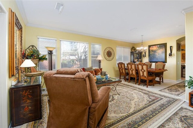 living room featuring an inviting chandelier and ornamental molding