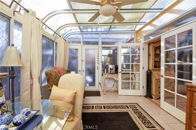 sunroom / solarium featuring ceiling fan and french doors