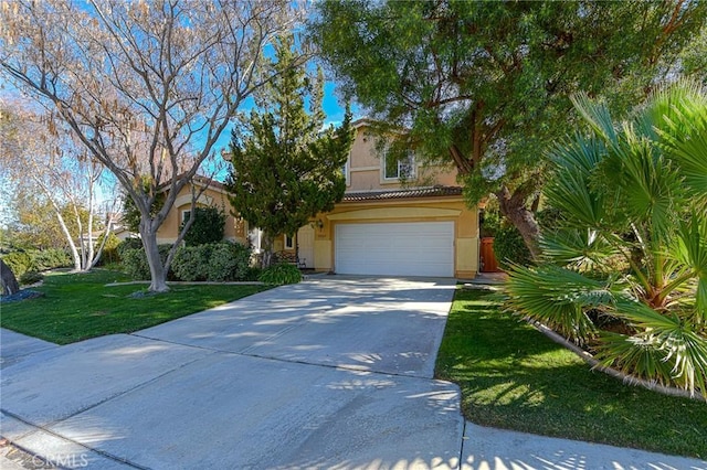 view of front of property featuring a front lawn and a garage