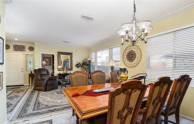 dining room with crown molding and a notable chandelier