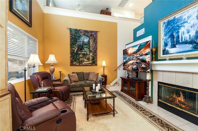 living room with ornamental molding and a fireplace