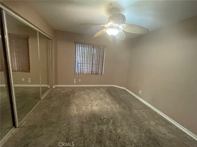 unfurnished bedroom with ceiling fan, a closet, and carpet floors