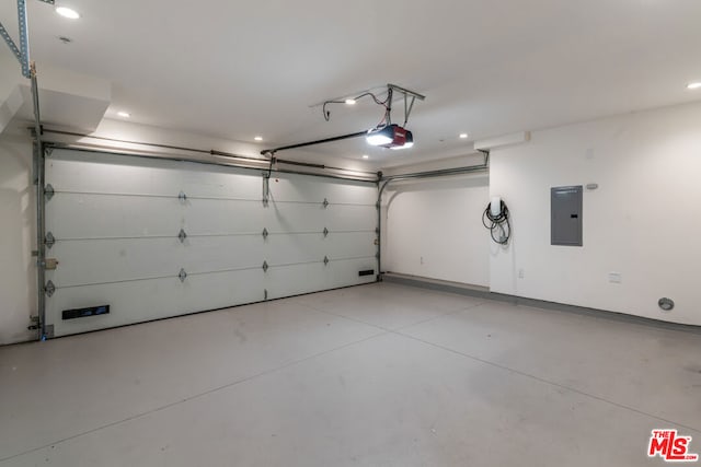 garage featuring a garage door opener and electric panel