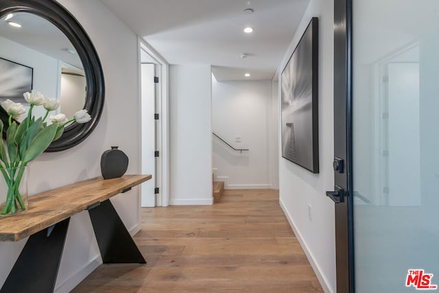 corridor with light hardwood / wood-style floors