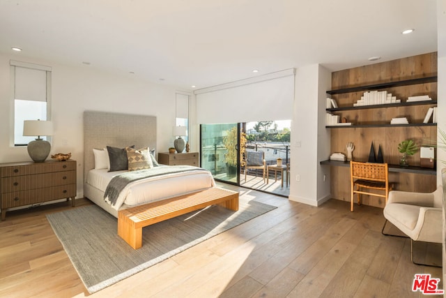 bedroom featuring access to exterior and light hardwood / wood-style flooring