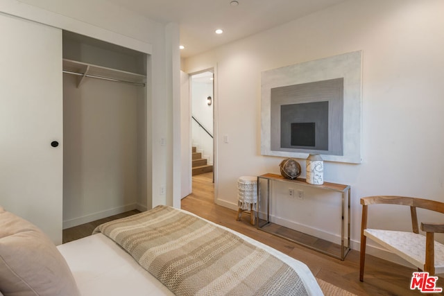 bedroom with a closet and wood-type flooring