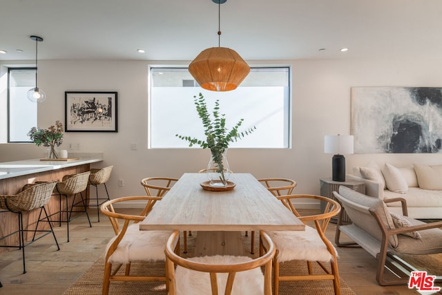 dining space with plenty of natural light and light hardwood / wood-style flooring