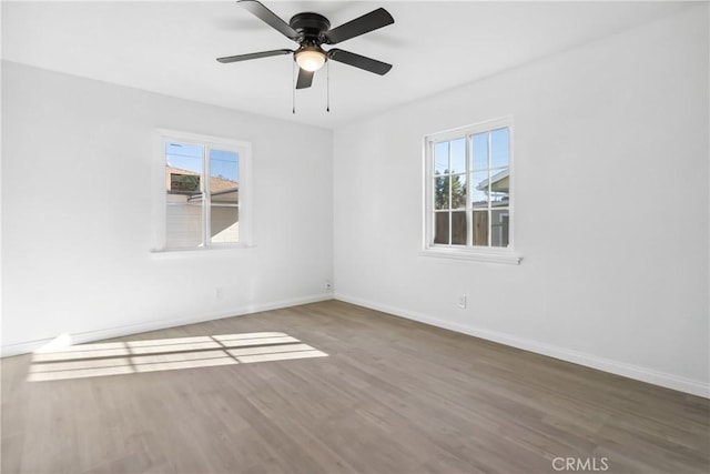 empty room with ceiling fan and wood-type flooring