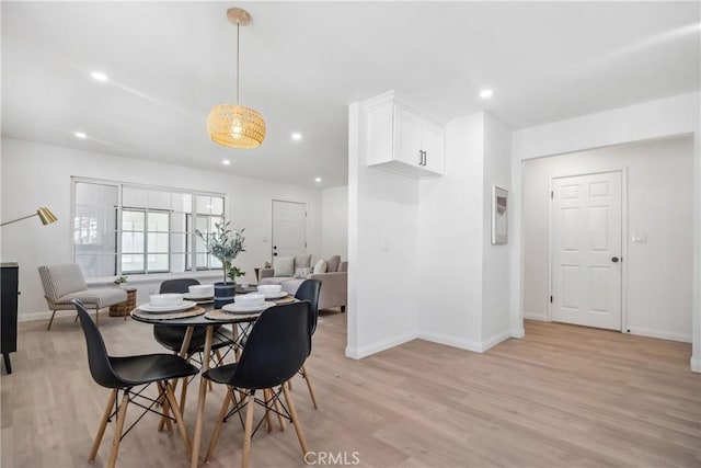 dining space featuring light wood-type flooring