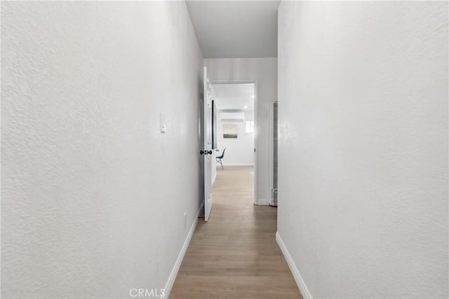 hallway with light wood-type flooring