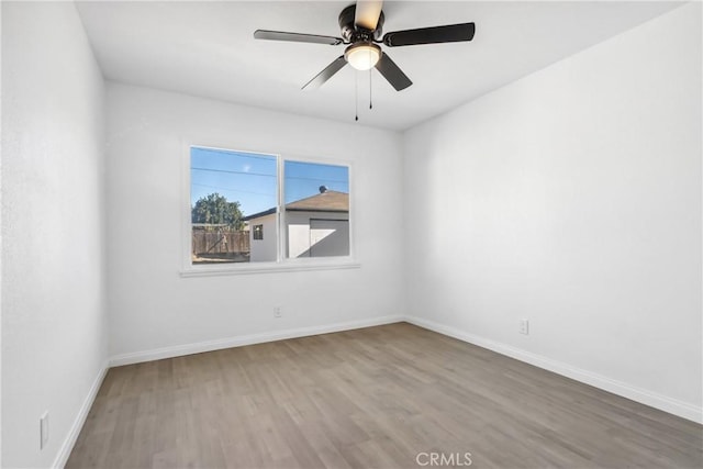 unfurnished room with ceiling fan and hardwood / wood-style flooring