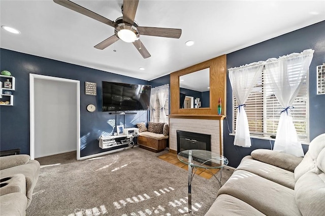 living room with ceiling fan, a fireplace, and carpet floors