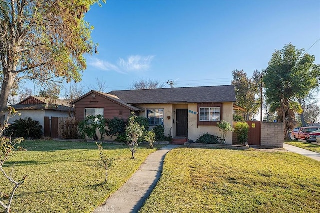 single story home featuring a front lawn