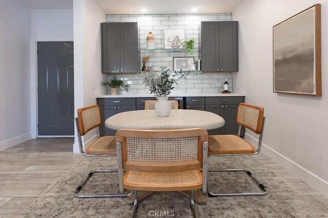 interior space featuring light hardwood / wood-style floors, backsplash, and gray cabinetry