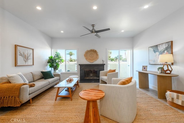 living room with ceiling fan and light wood-type flooring