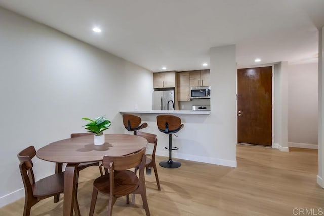 dining area featuring light wood-type flooring