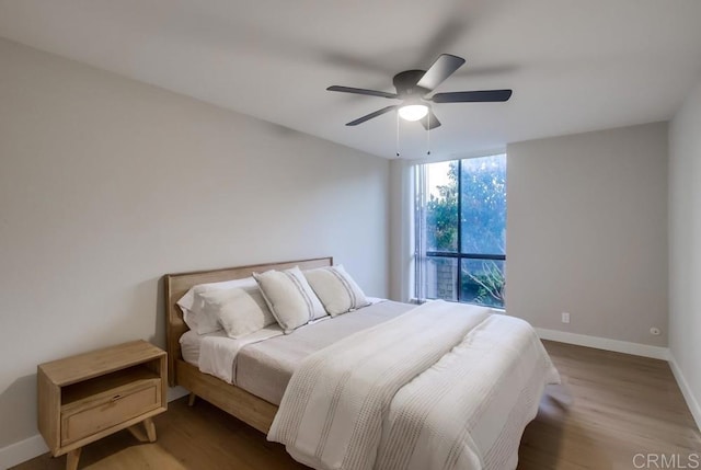 bedroom featuring ceiling fan and wood-type flooring