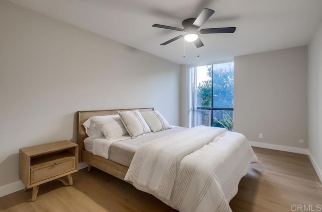 bedroom with ceiling fan and hardwood / wood-style floors