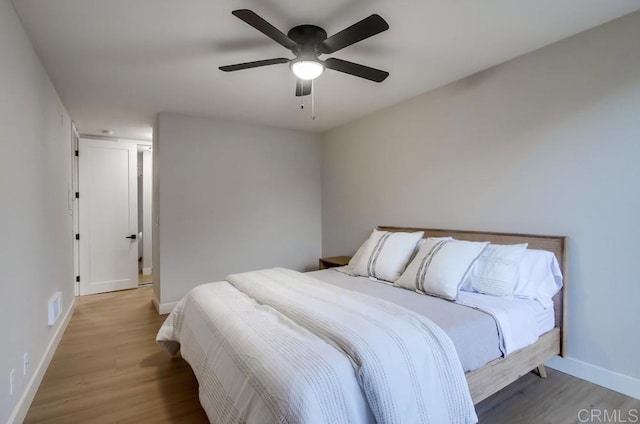 bedroom with light wood-type flooring and ceiling fan