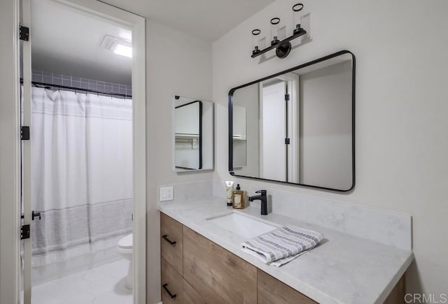 bathroom with toilet, tile patterned floors, vanity, and curtained shower