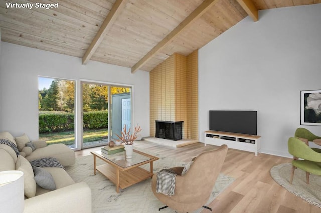 living room with wood ceiling, light wood-type flooring, lofted ceiling with beams, and a fireplace