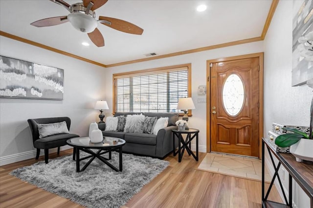 living room with ornamental molding, ceiling fan, and hardwood / wood-style floors