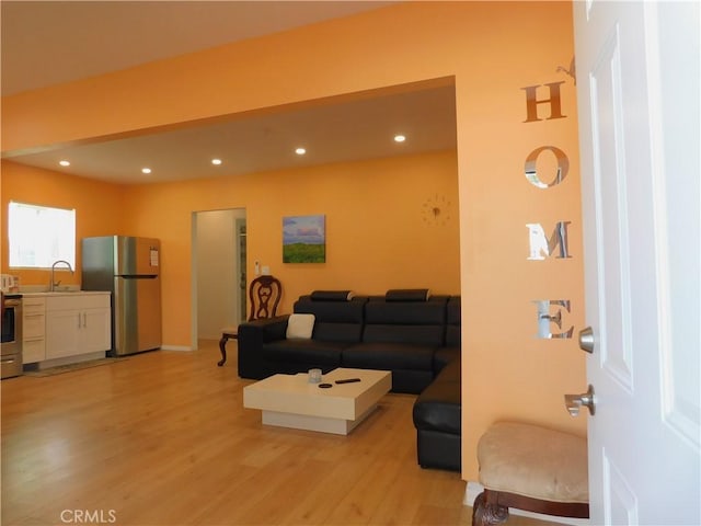 living room with light wood finished floors and recessed lighting