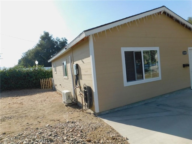 view of side of property featuring fence