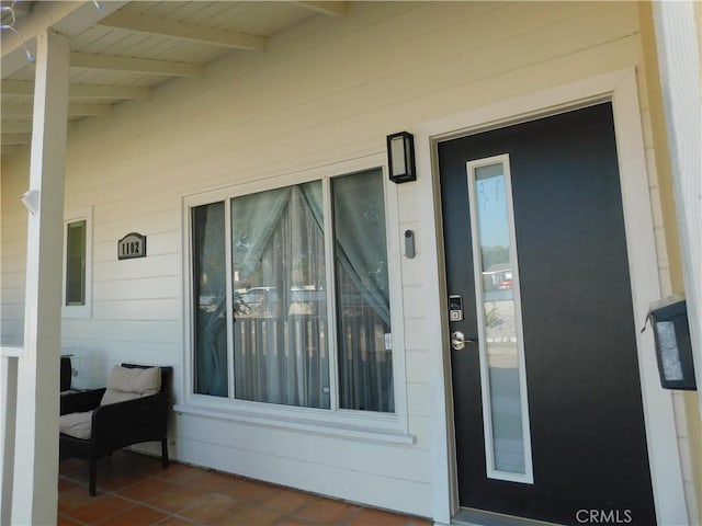 entrance to property featuring covered porch