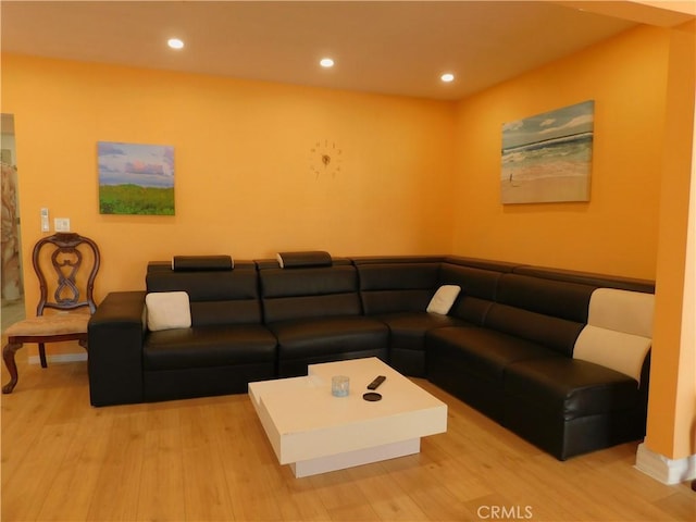 living room with recessed lighting and wood finished floors