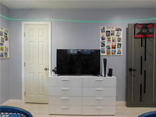 bedroom featuring baseboards and light wood-style flooring