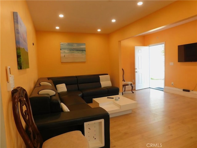 living room with recessed lighting and wood finished floors