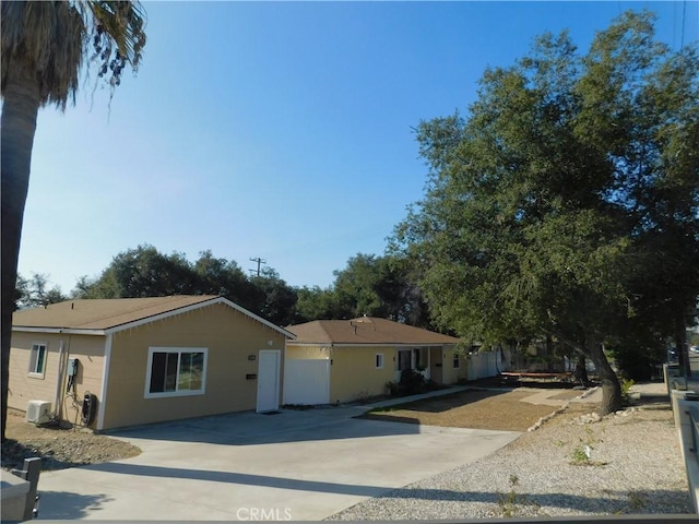 single story home with concrete driveway