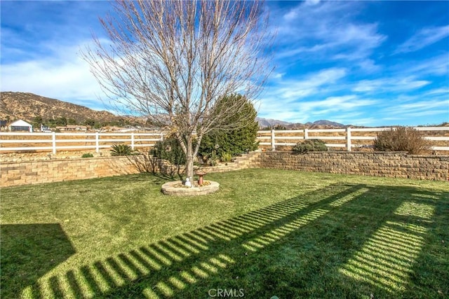 view of yard featuring a fenced backyard and a mountain view