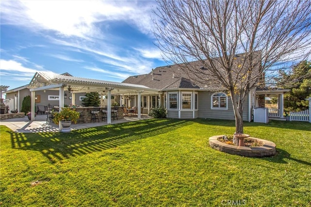 back of house featuring a lawn, fence, a pergola, and a patio area