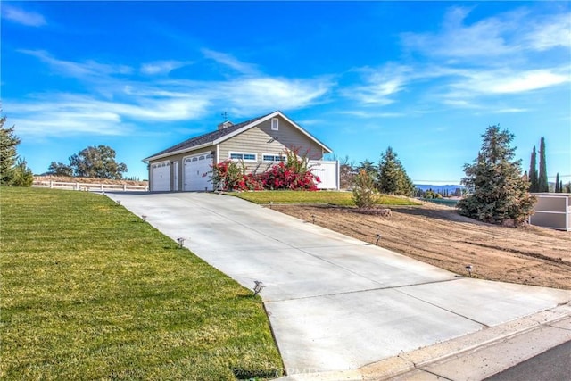 ranch-style home featuring a garage, driveway, and a front lawn