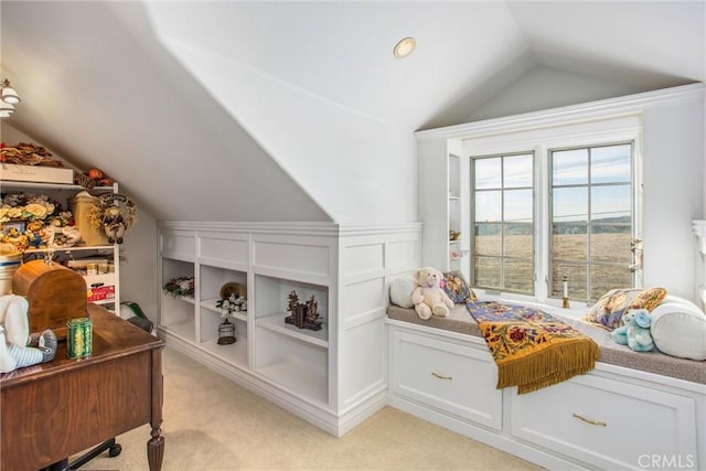 bedroom with light colored carpet and lofted ceiling