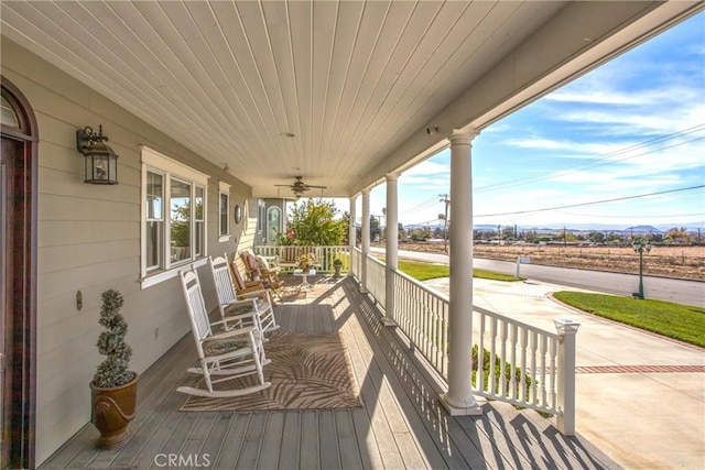 deck featuring a ceiling fan and covered porch